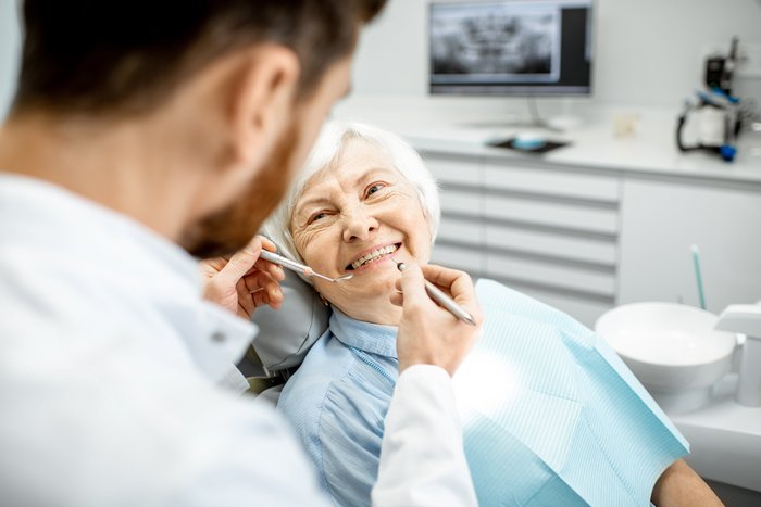 Zahnarztpraxis am Sterntor wird eine Frau auf dem Behandlungsstuhl von einem engagierten Team an Parodontologie-Experten betreut